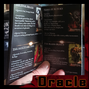 Hand flipping through the Oracle of Shadows guidebook by Cyb, an illustrated guide to gothic and symbolic cards.